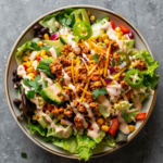 Chopped Southwest Salad with Taco Ranch dressing, fresh vegetables, and tortilla chips in a bowl